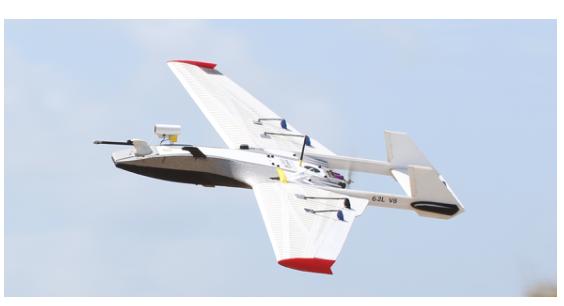 RAAVEN fixed-wing test aircraft in flight against a blue sky