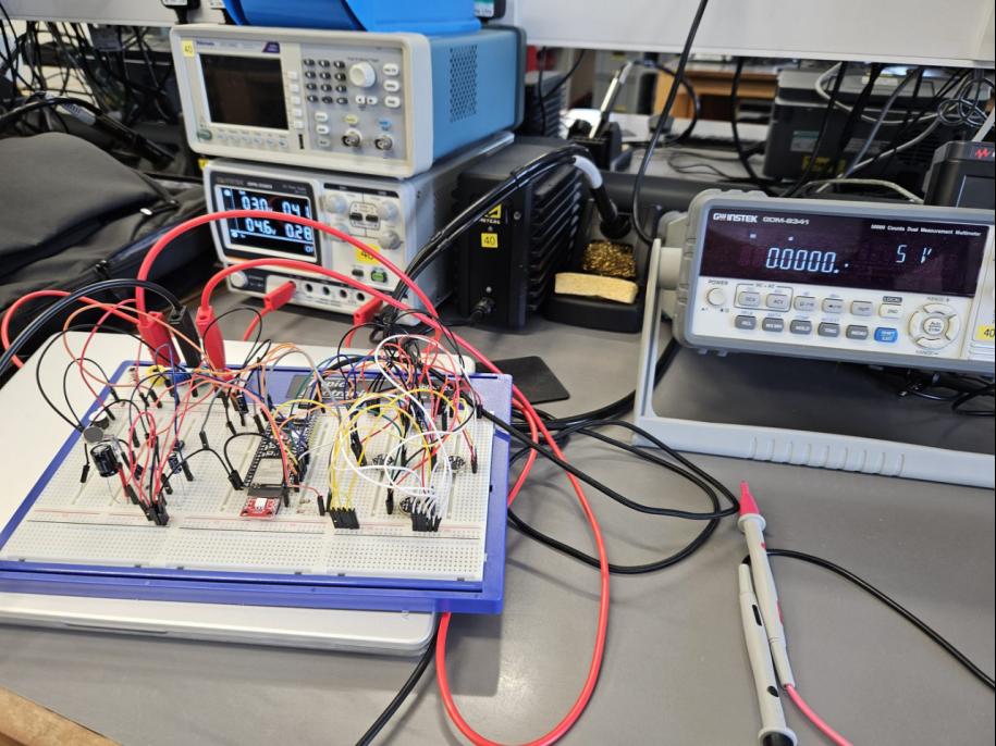 VolAnti breadboard prototype on a bench with oscilloscope and power supply